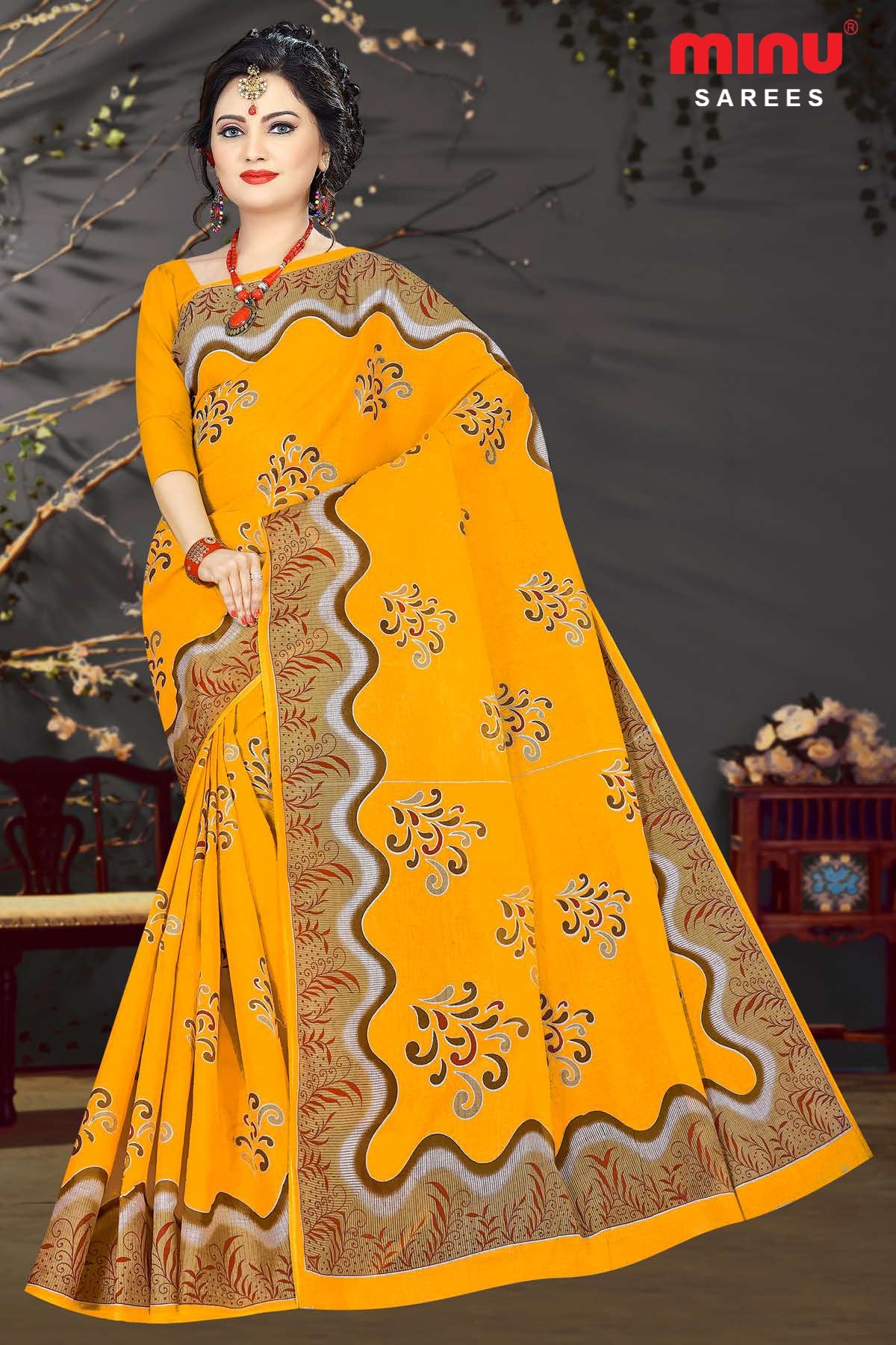 Women standing in bold yellow color printed saree image